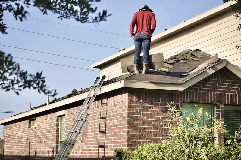 Professional roofer working on a residential roof in Pecksville